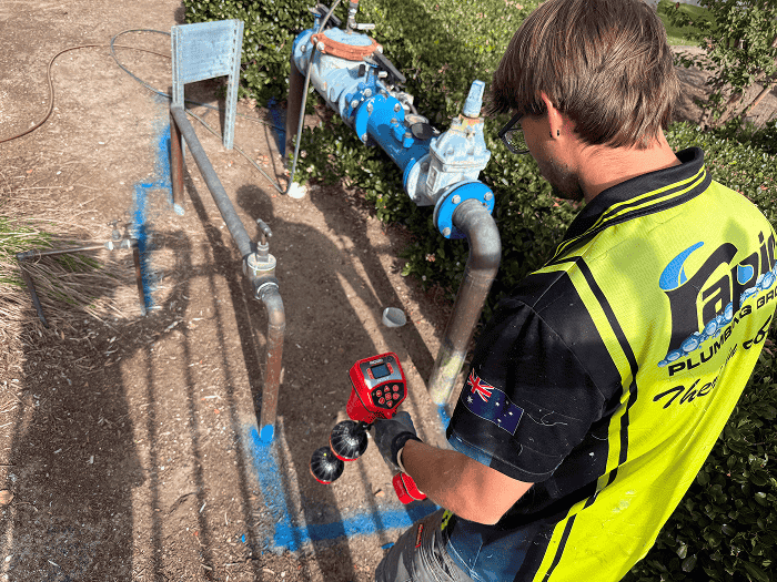Technician carrying out commercial leak detection